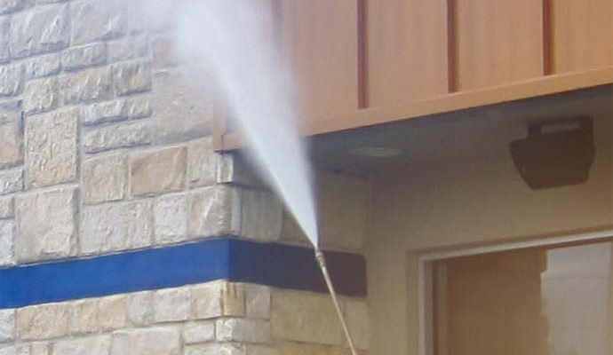 Using water pressure to clean commercial buildings.