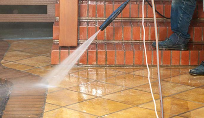 Worker is washing Concrete and Brick