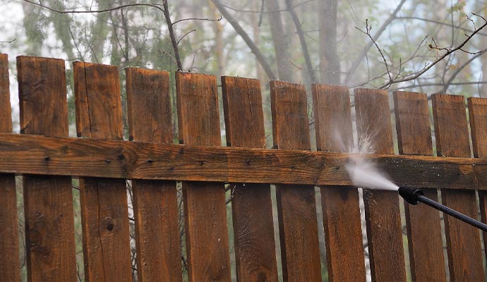 gardening in cleaning of wooden fence with high pressure washing