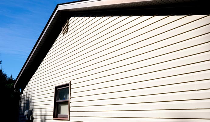 house with pale yellow vinyl siding