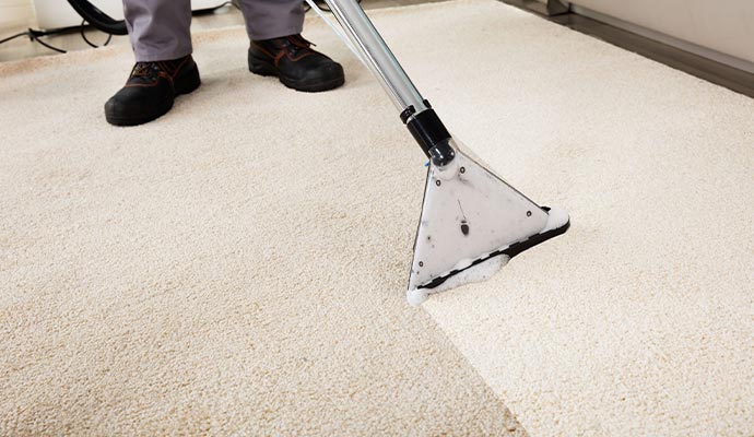 man using carpet cleaning equipment