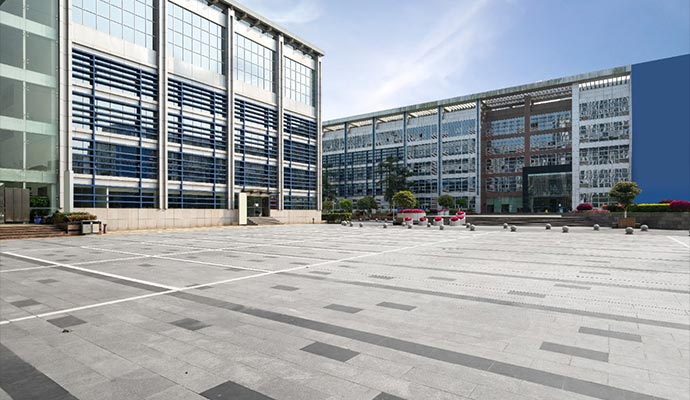 office building in sidewalk and parking lots