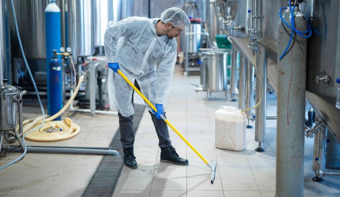 professional industrial properties cleaner in protective uniform cleaning floor