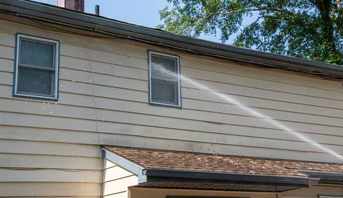 water spraying on the siding of a house